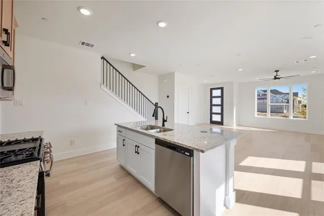 a kitchen with granite countertop a stove and a sink