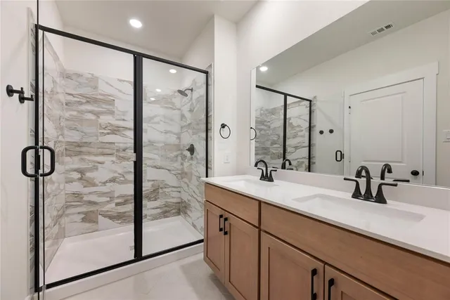 a bathroom with a shower sink and mirror