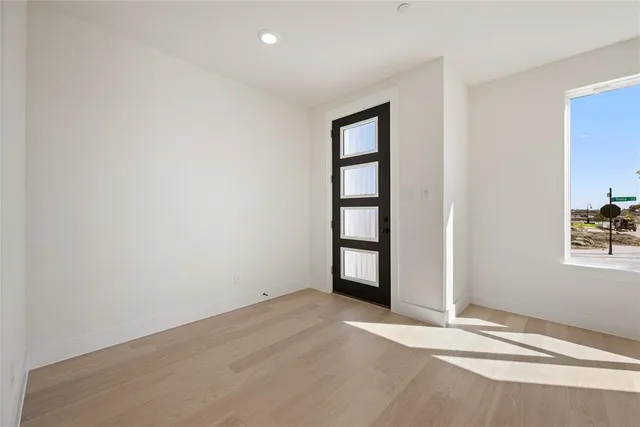 an empty room with windows and closet