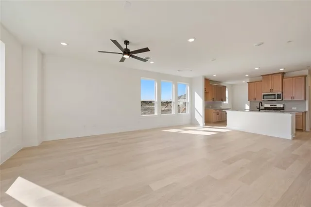 a view of a kitchen with a sink and a window