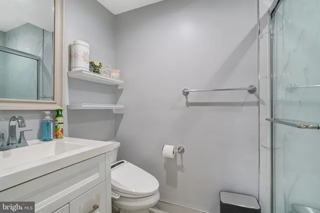 a bathroom with a toilet a sink and shower