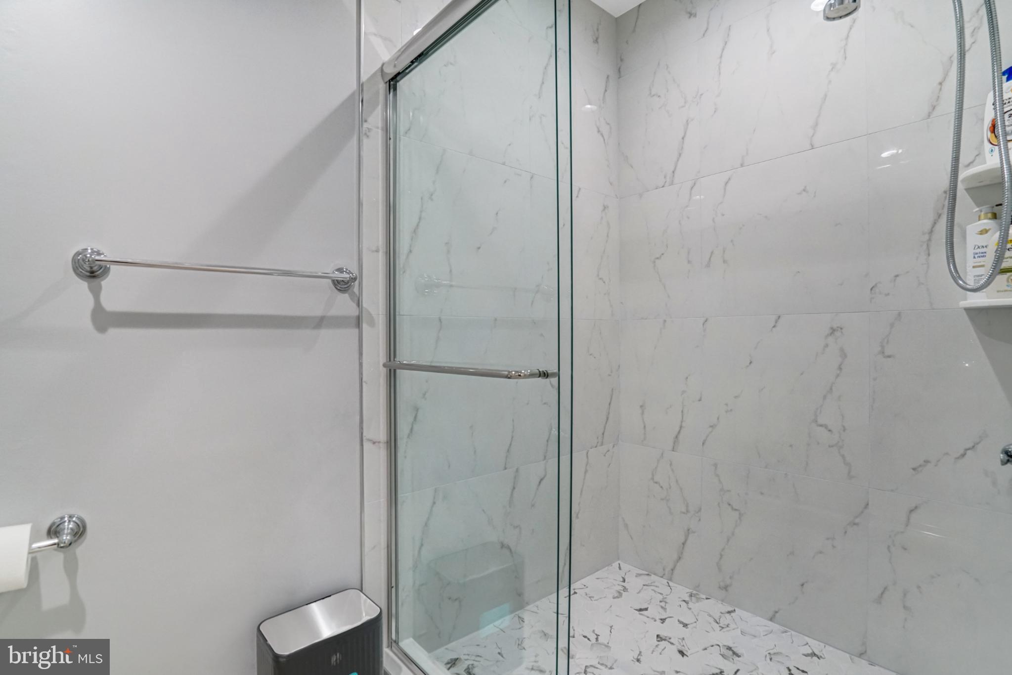 7727 Kalorama Road Annandale, VA 22003 - Photo 13 of 51 Sleek modern shower with elegant marble tiles.