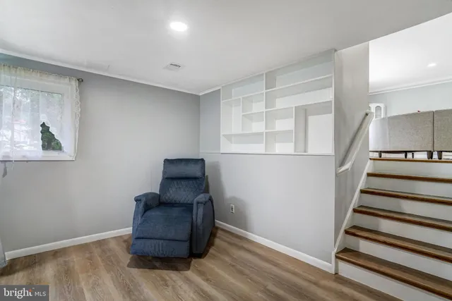 a room with stairs and wooden floor