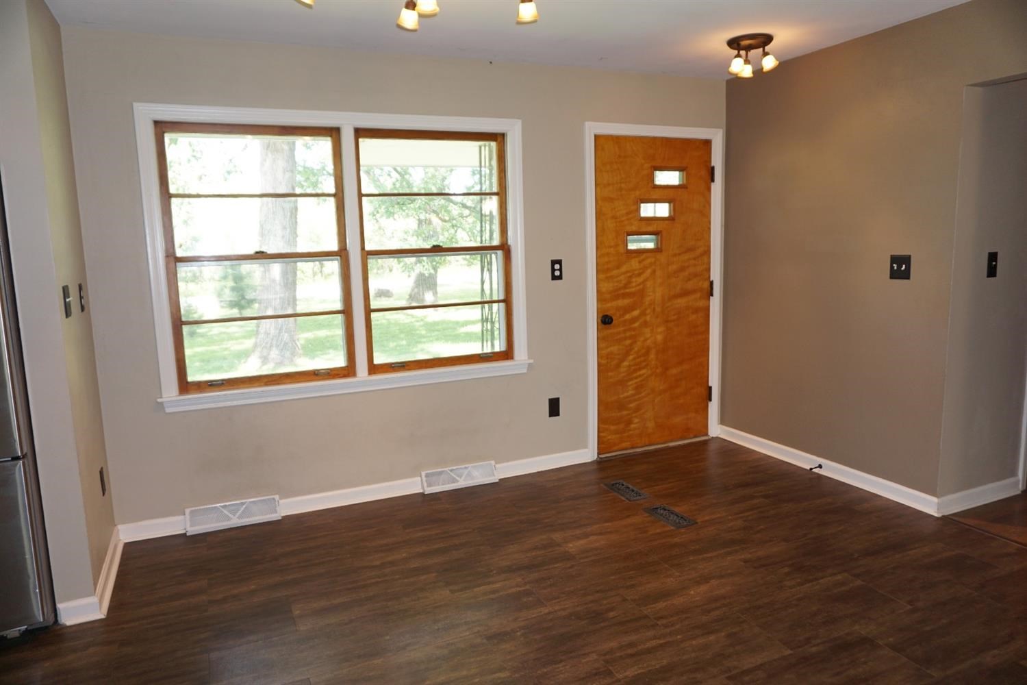 10420 Clark Road Crown Point, IN 46307 - Photo 3 of 9 a view of an empty room with wooden floor and a window