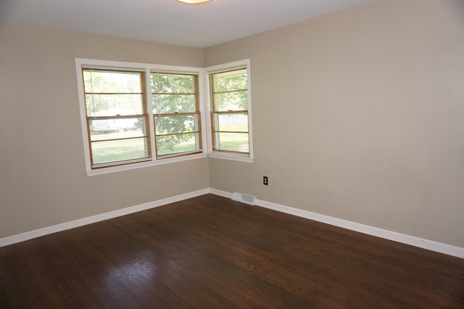 10420 Clark Road Crown Point, IN 46307 - Photo 6 of 9 an empty room with wooden floor and windows