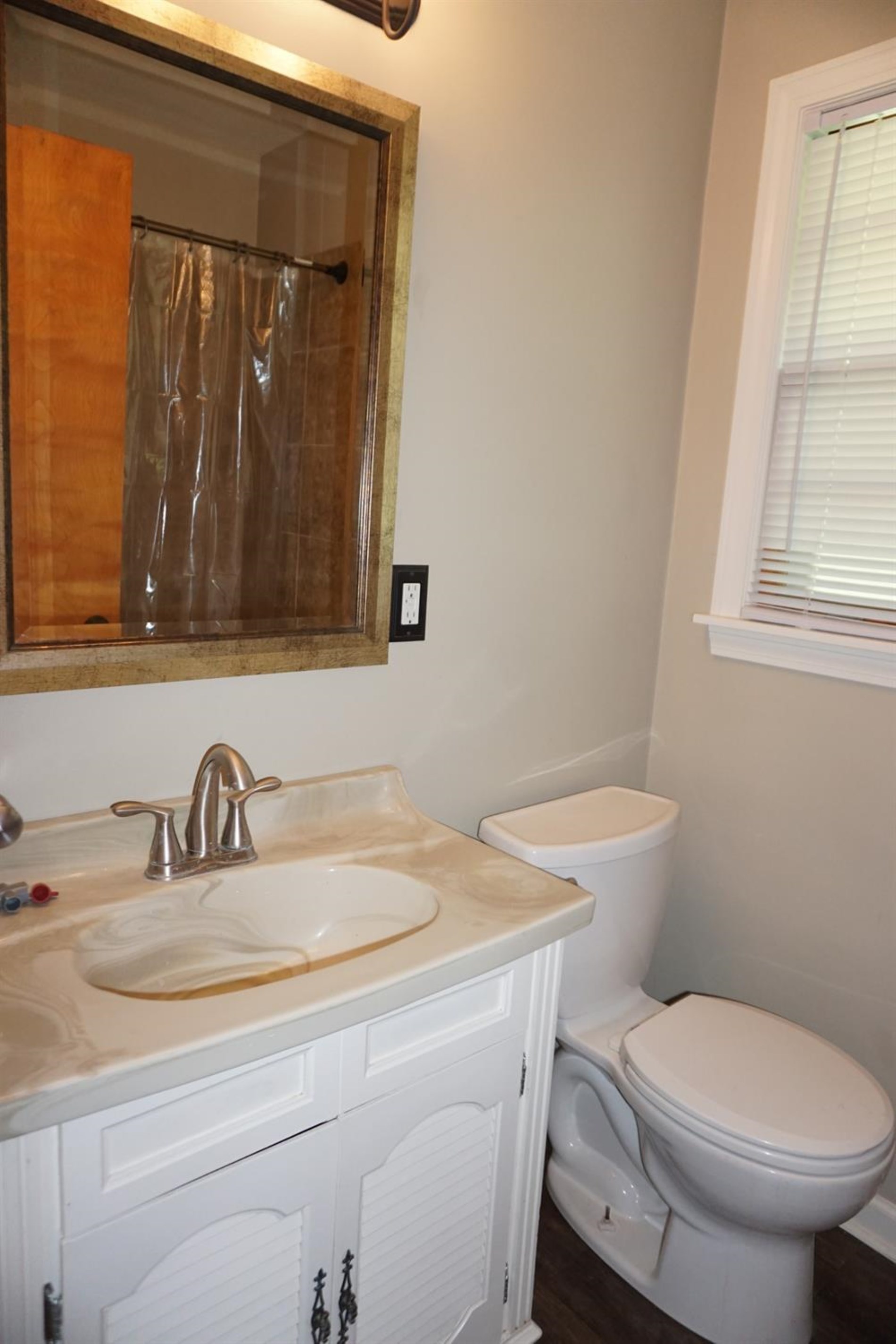 10420 Clark Road Crown Point, IN 46307 - Photo 7 of 9 a bathroom with a toilet a sink and mirror