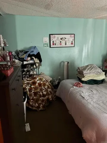 a bedroom with a bed and ceiling fan