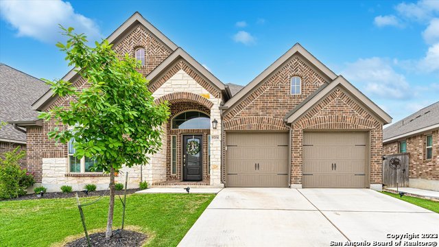 9704 Innes Place Boerne, TX 78006 - Photo 1 of 1 a front view of a house with a yard and garage