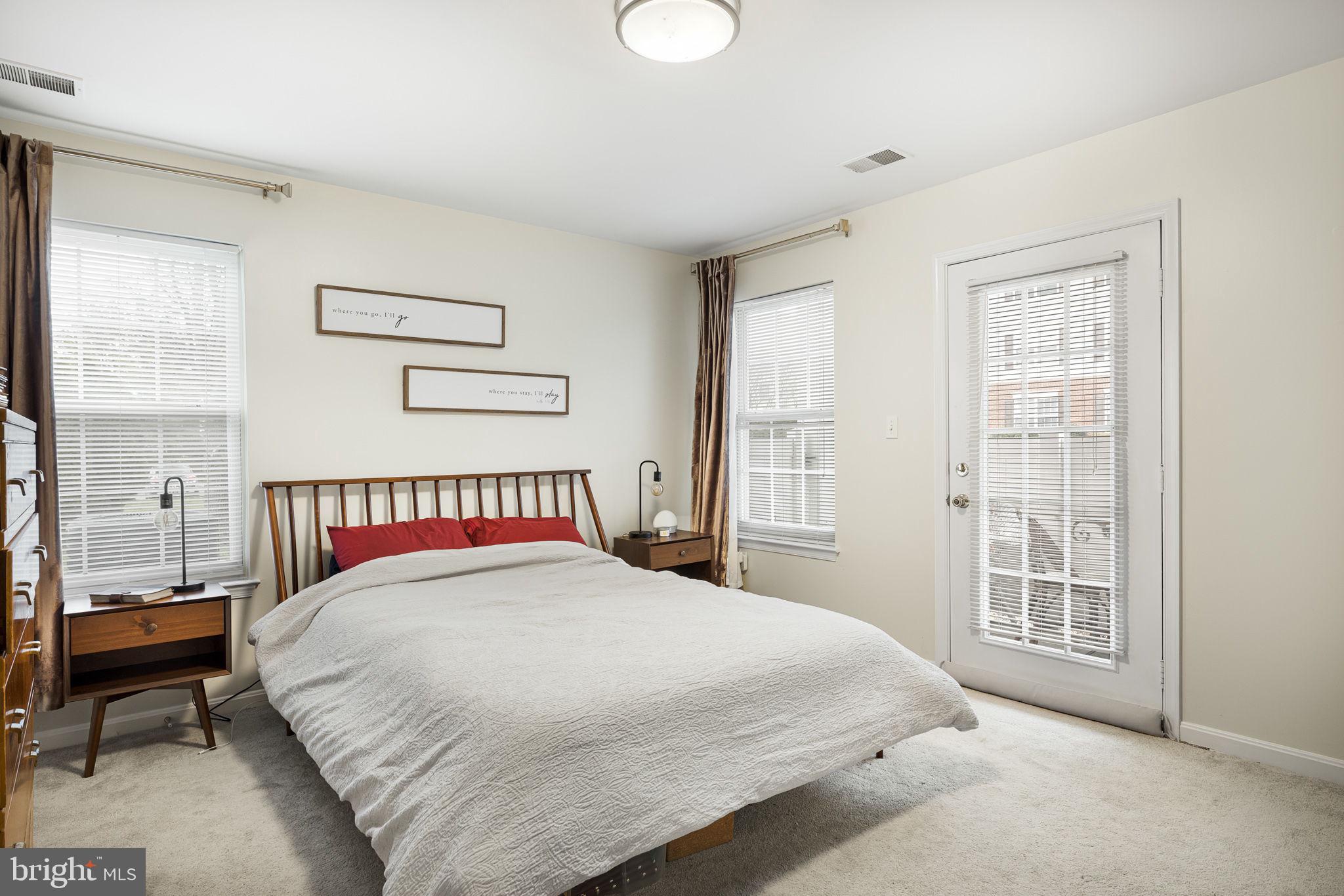 645 Constellation Square Southeast, Unit B Leesburg, VA 20175 - Photo 12 of 17 a bedroom with a large bed and a window