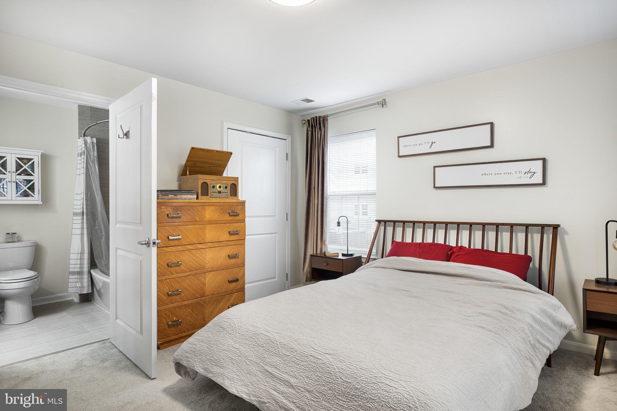 645 Constellation Square Southeast, Unit B Leesburg, VA 20175 - Photo 14 of 17 a bedroom with a bed and a view of bathroom