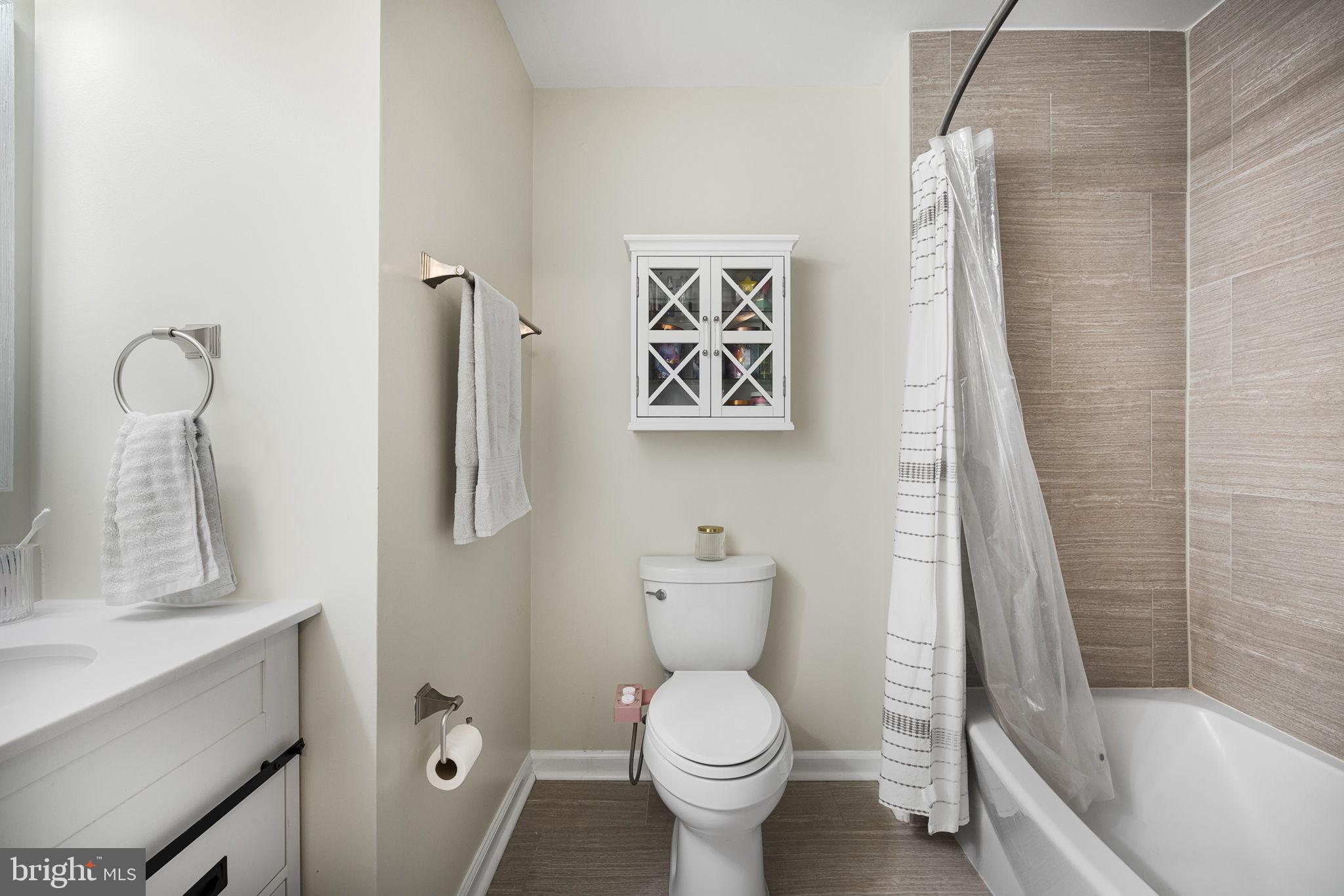 645 Constellation Square Southeast, Unit B Leesburg, VA 20175 - Photo 15 of 17 a bathroom with a toilet sink and shower