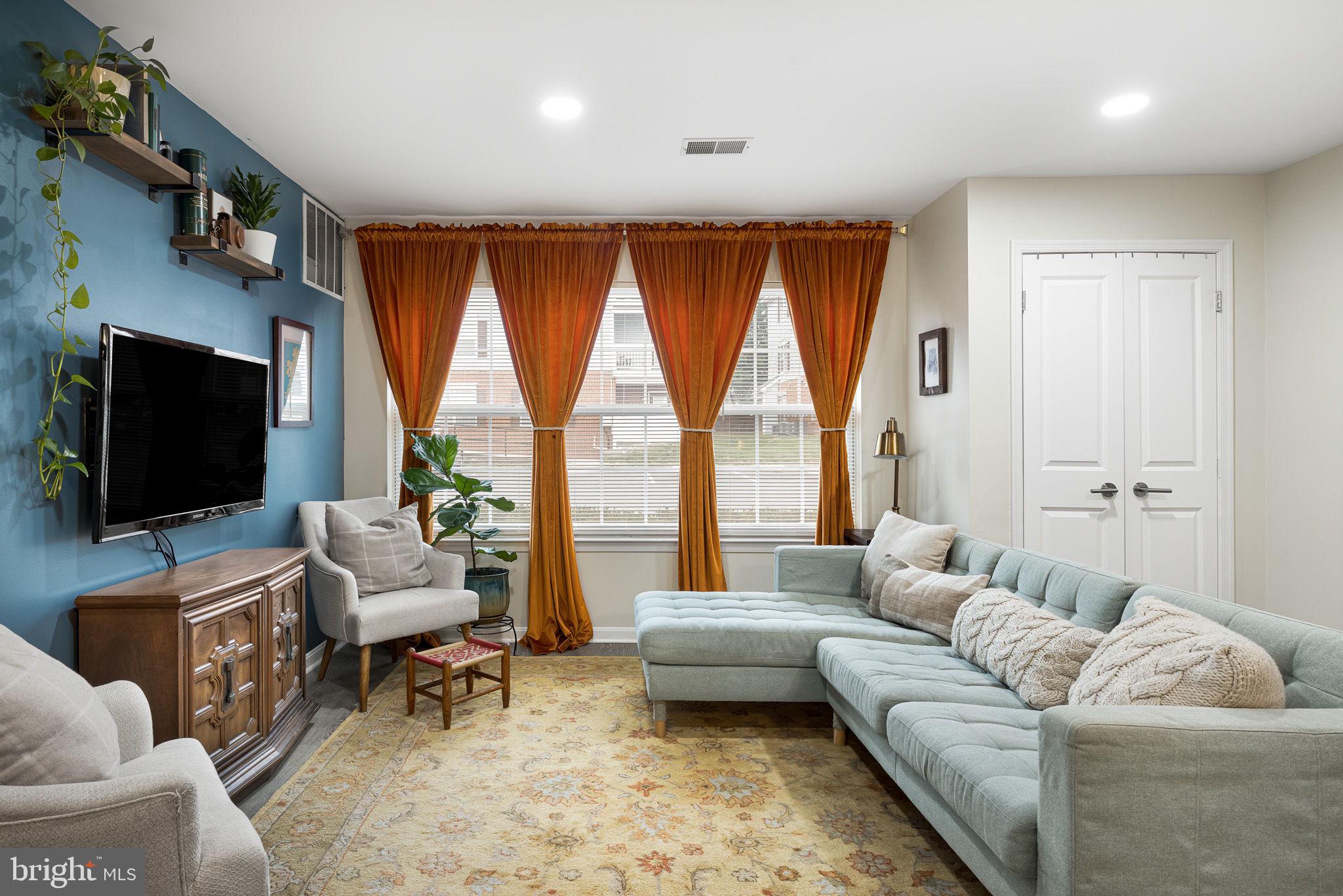 645 Constellation Square Southeast, Unit B Leesburg, VA 20175 - Photo 5 of 17 a living room with furniture and a flat screen tv