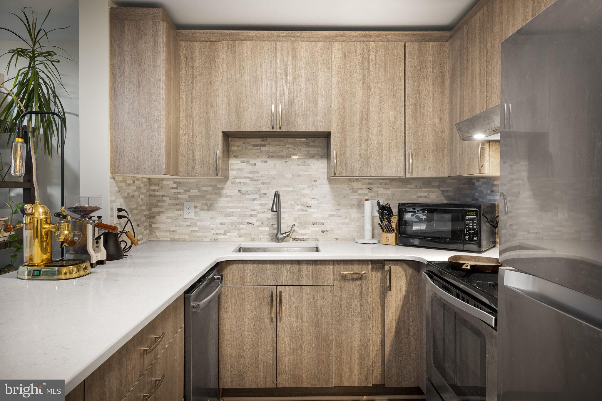 645 Constellation Square Southeast, Unit B Leesburg, VA 20175 - Photo 9 of 17 a kitchen with a sink cabinets and appliances