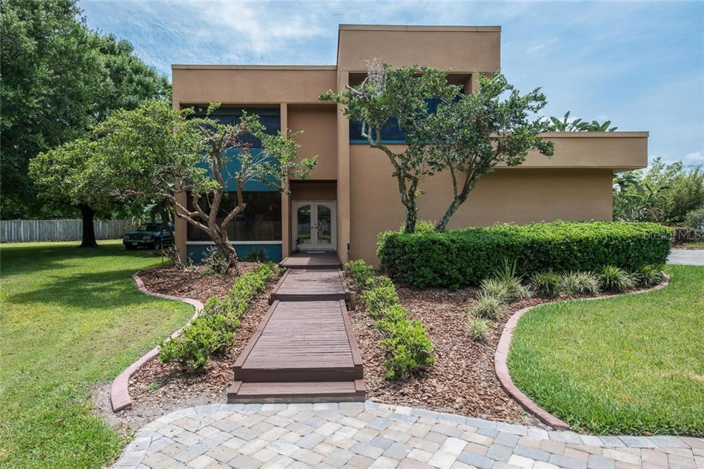 2333 McIntosh Road Dover, FL 33527 - Photo 1 of 1 a front view of a house with a yard and potted plants