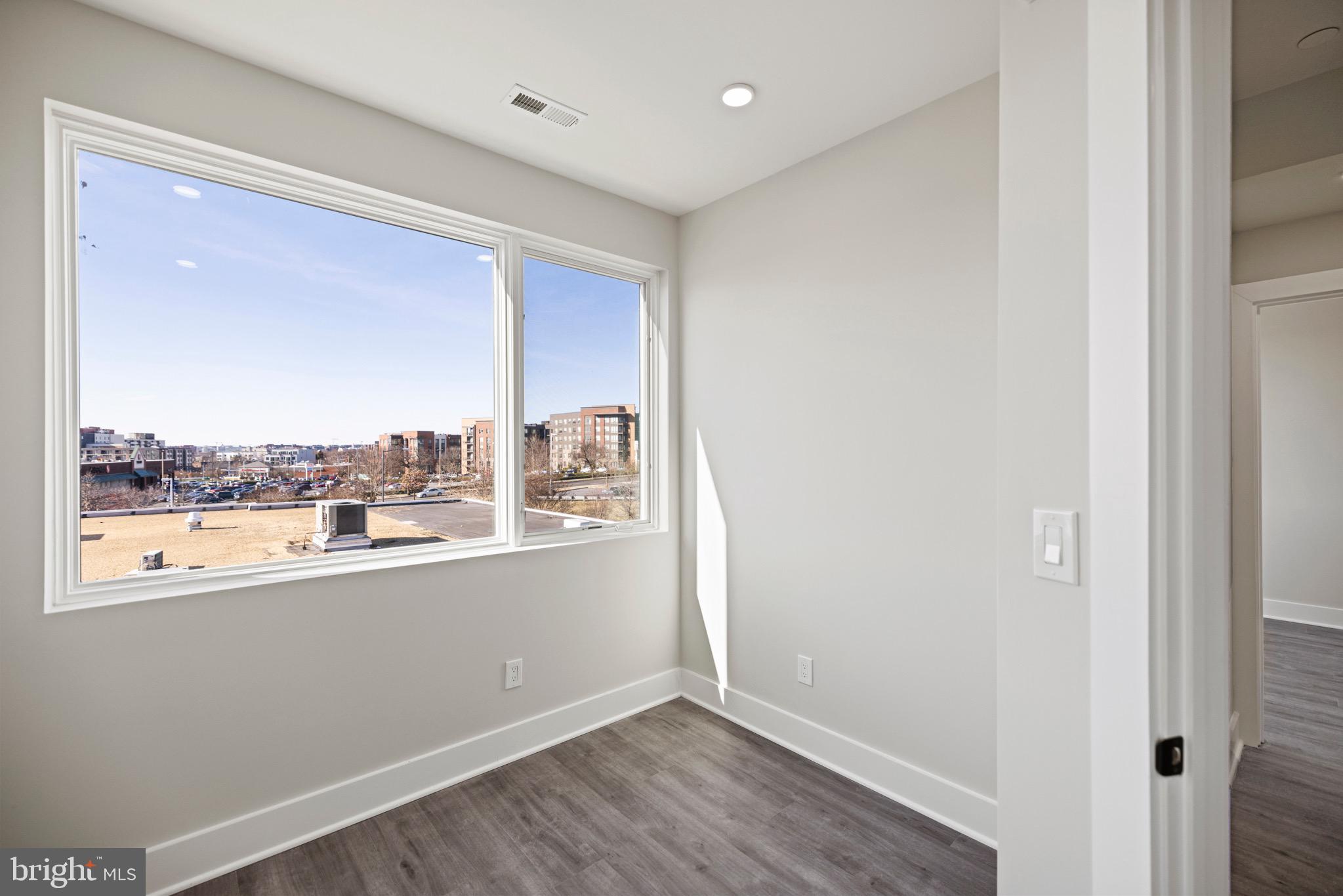 824 18th Street Northeast, Unit 304 Washington, DC 20002 - Photo 12 of 25 a view of a room with wooden floor and window
