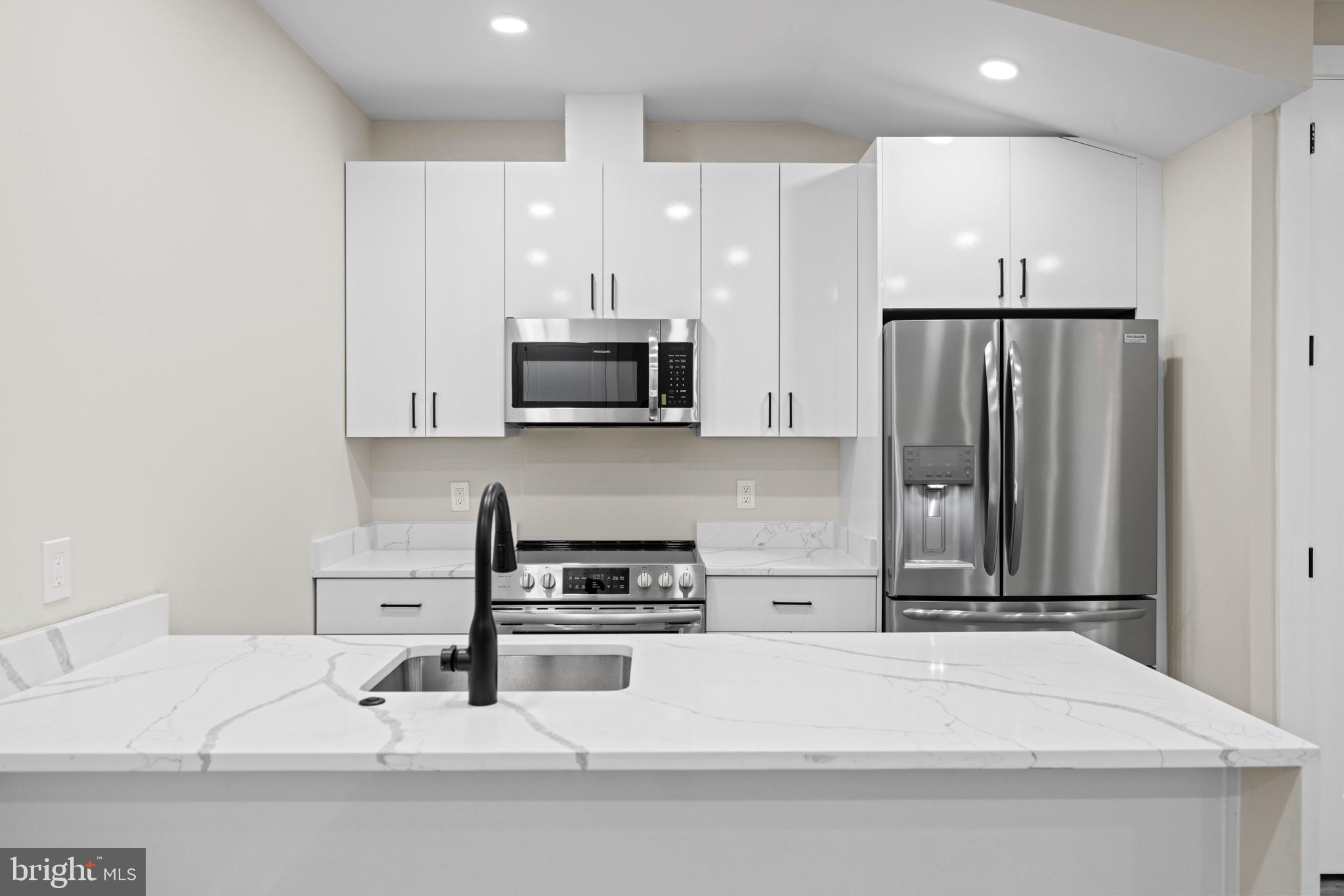 824 18th Street Northeast, Unit 304 Washington, DC 20002 - Photo 16 of 25 a kitchen with stainless steel appliances a refrigerator sink and microwave