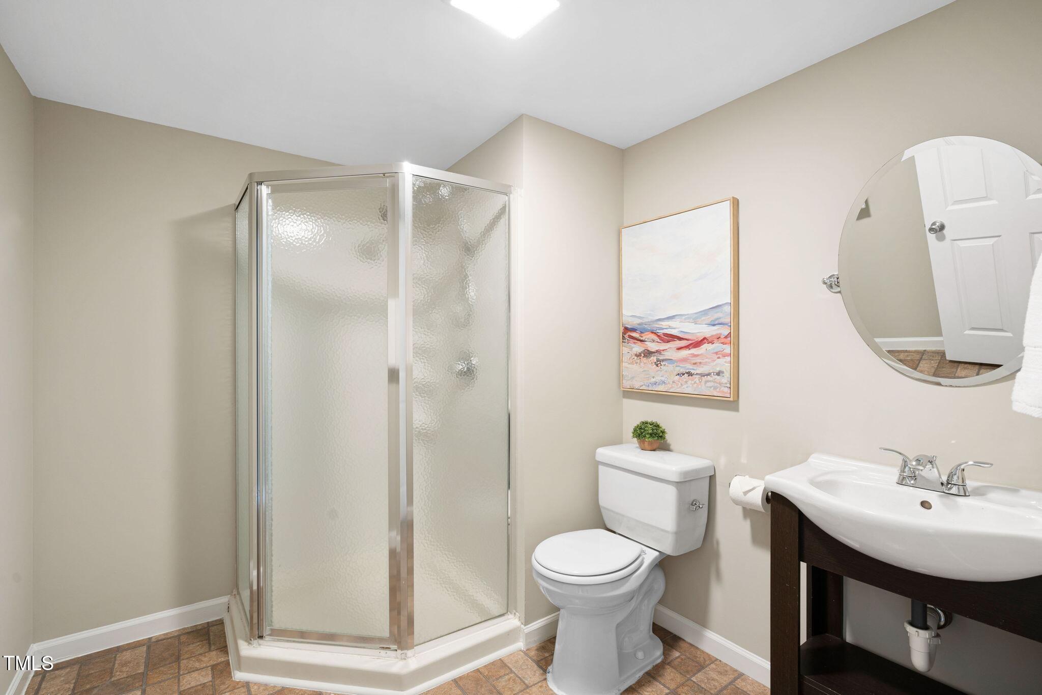 3302 Colorcott Street Raleigh, NC 27614 - Photo 15 of 17 a bathroom with a toilet a sink and a mirror