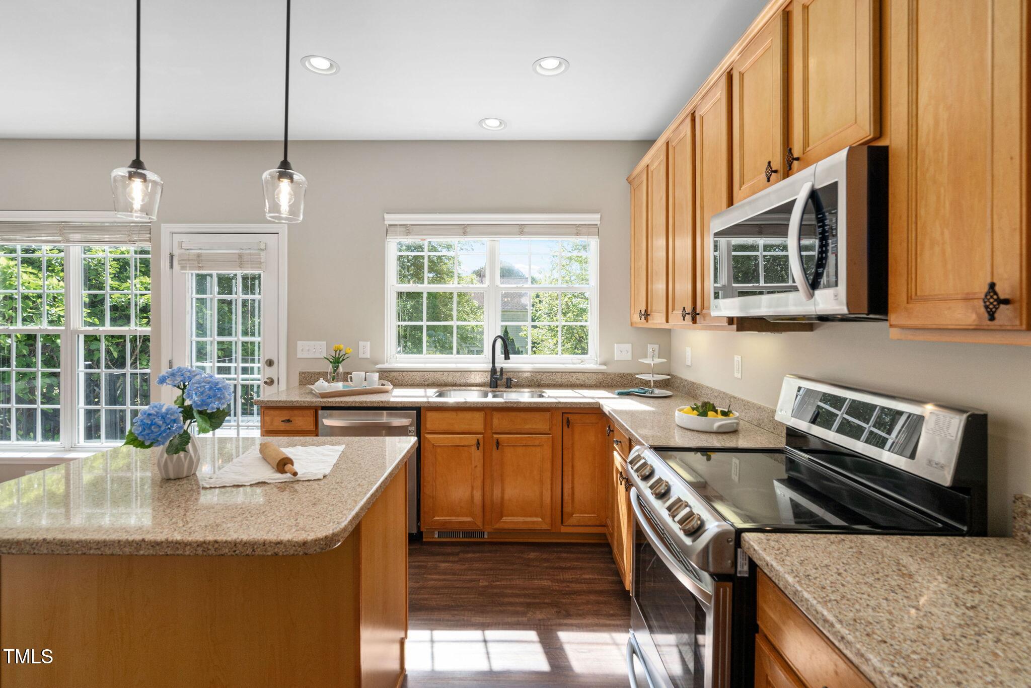 3302 Colorcott Street Raleigh, NC 27614 - Photo 3 of 17 a kitchen with stainless steel appliances granite countertop a stove a sink and a microwave