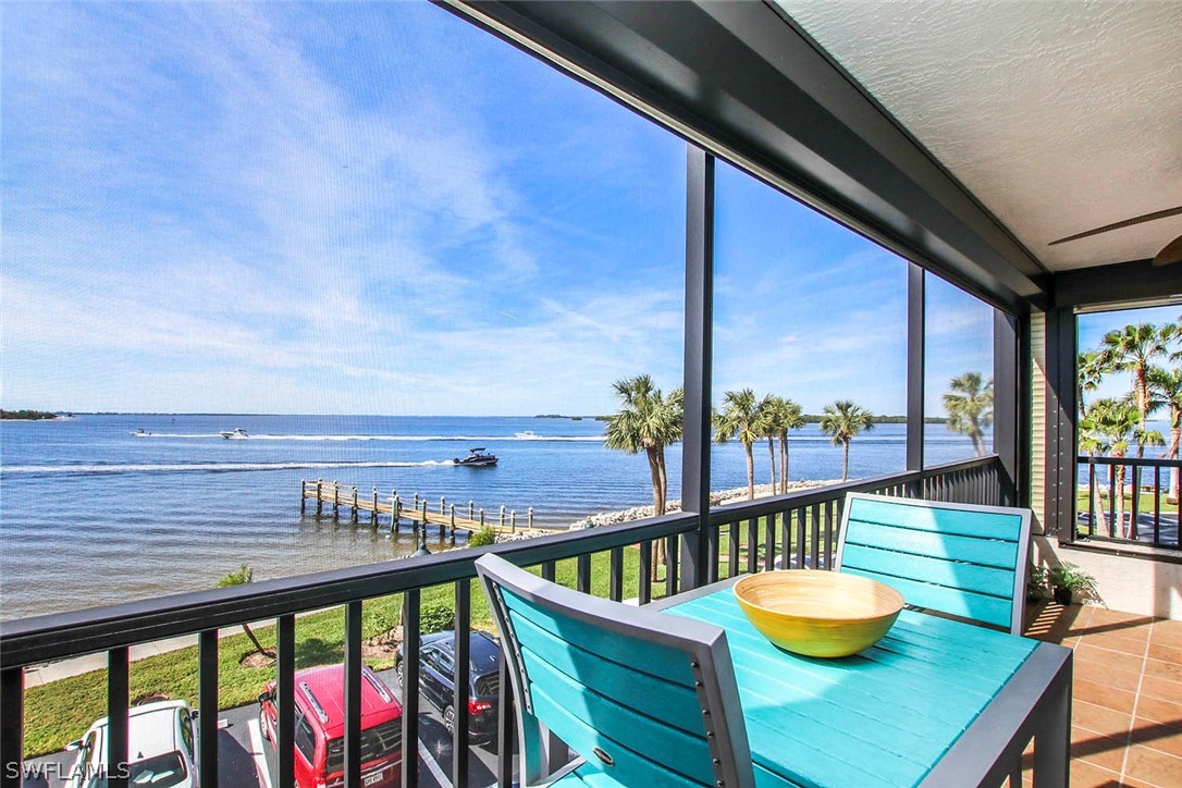15011 Punta Rassa Road, Unit 204 Fort Myers, FL 33908 - Photo 12 of 23 a view of a balcony with chairs