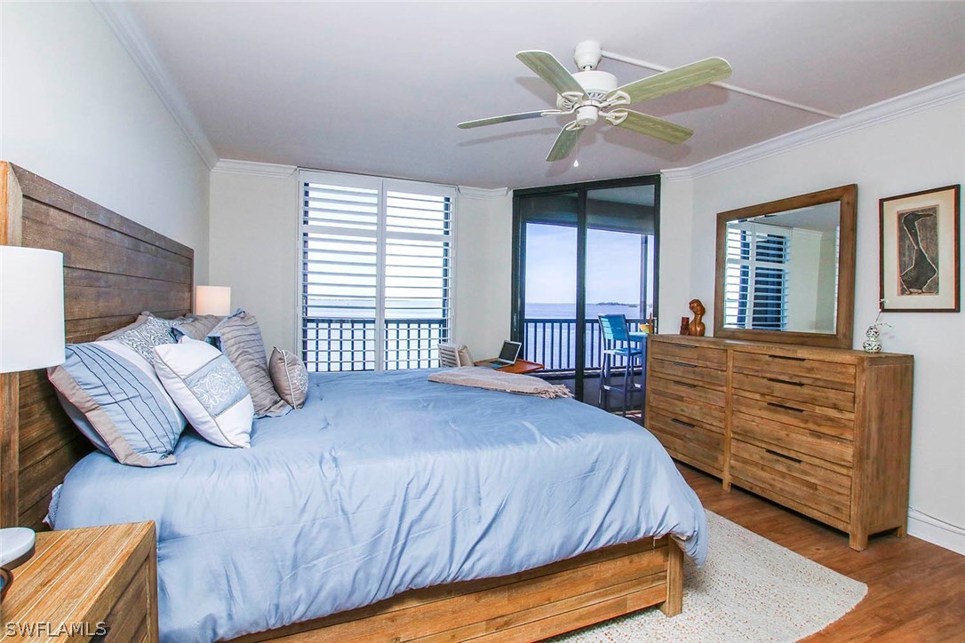 15011 Punta Rassa Road, Unit 204 Fort Myers, FL 33908 - Photo 13 of 23 a bedroom with a large bed and a chandelier