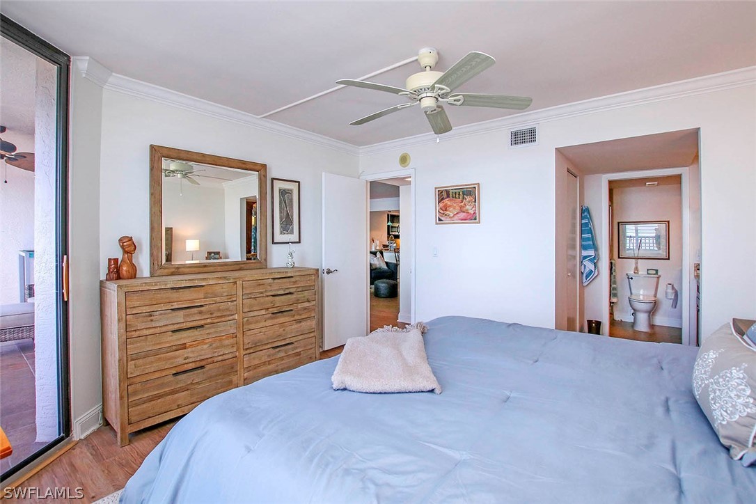 15011 Punta Rassa Road, Unit 204 Fort Myers, FL 33908 - Photo 14 of 23 a bedroom with a bed and a chandelier