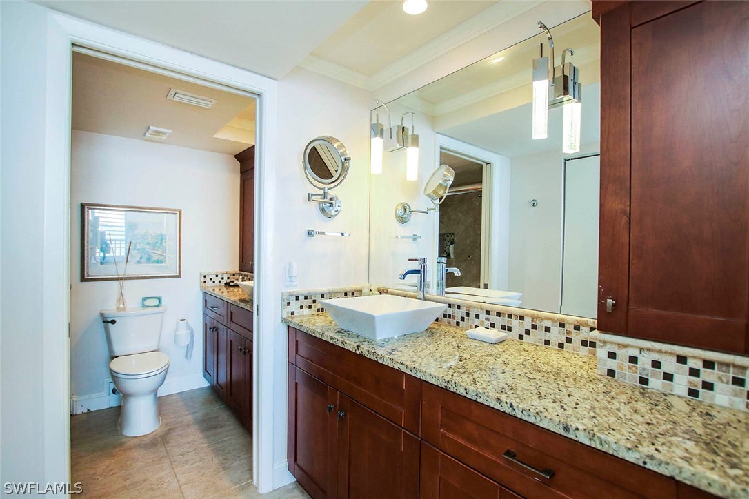 15011 Punta Rassa Road, Unit 204 Fort Myers, FL 33908 - Photo 15 of 23 a bathroom with a granite countertop sink and a mirror