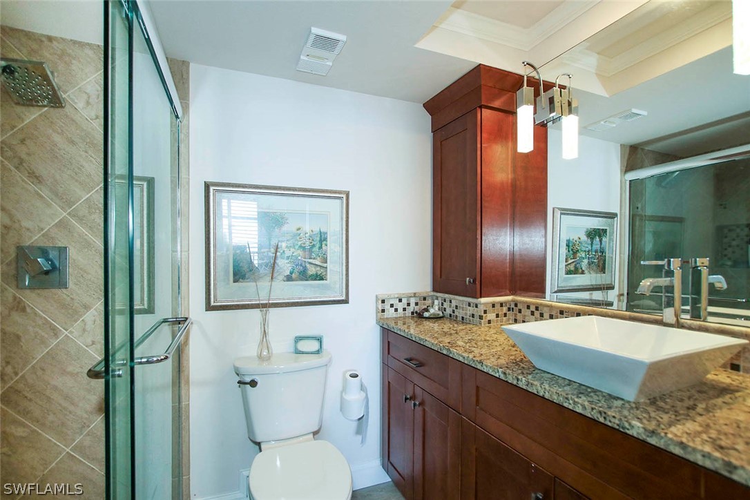 15011 Punta Rassa Road, Unit 204 Fort Myers, FL 33908 - Photo 16 of 23 a bathroom with a granite countertop sink toilet and shower