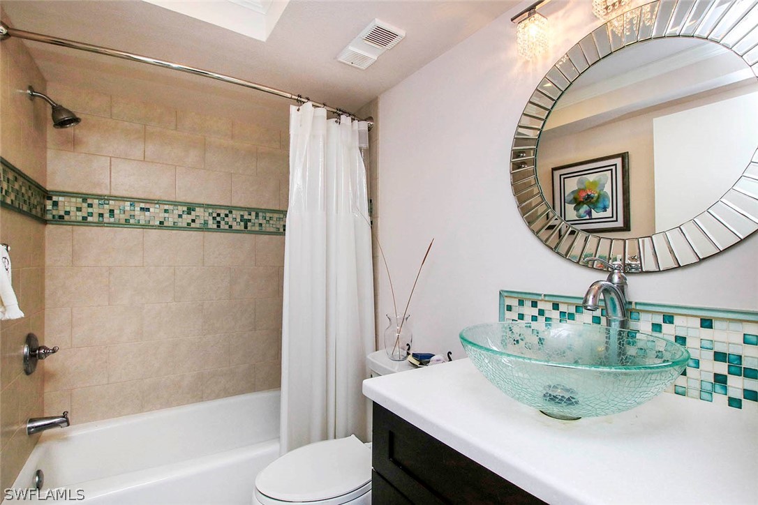 15011 Punta Rassa Road, Unit 204 Fort Myers, FL 33908 - Photo 18 of 23 a bathroom with a sink mirror and a bathtub