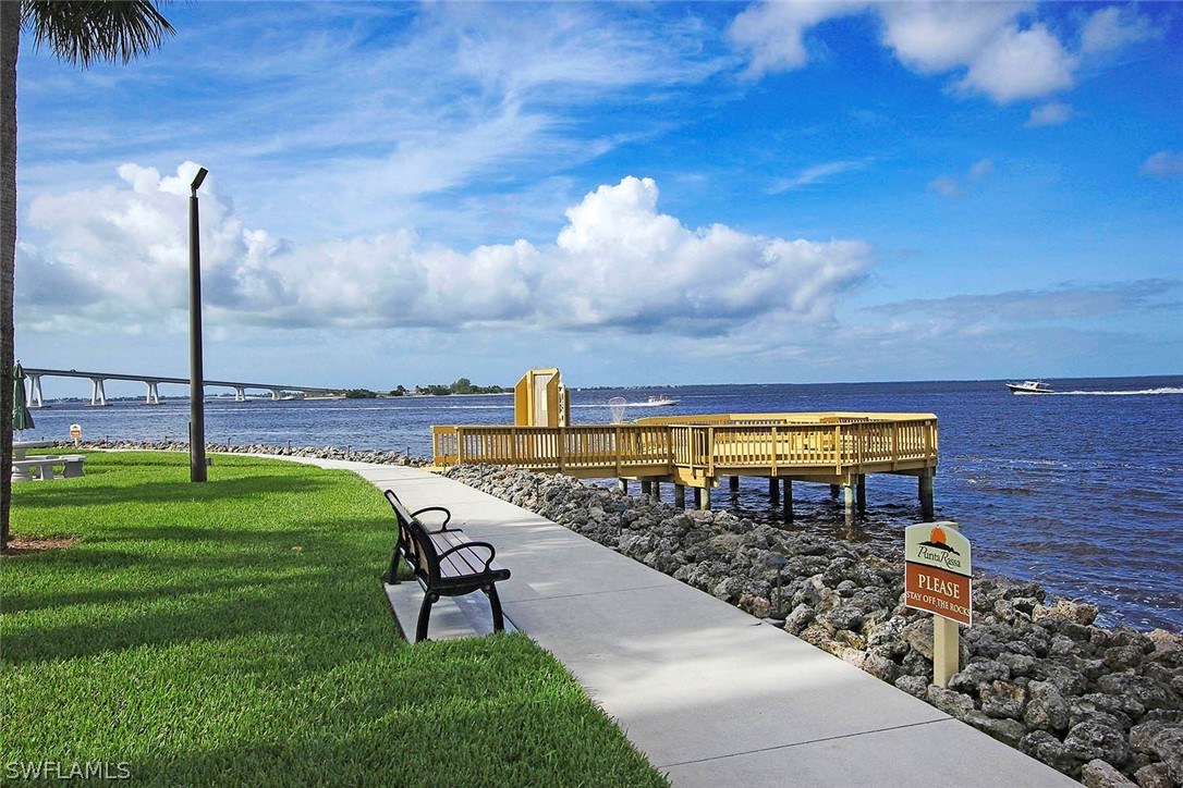 15011 Punta Rassa Road, Unit 204 Fort Myers, FL 33908 - Photo 19 of 23 a view of a swimming pool with a garden