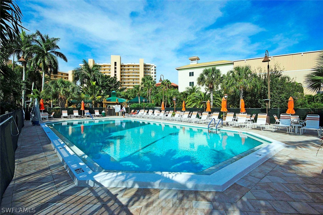 15011 Punta Rassa Road, Unit 204 Fort Myers, FL 33908 - Photo 3 of 23 swimming pool view with a seating space and a ocean view in the background