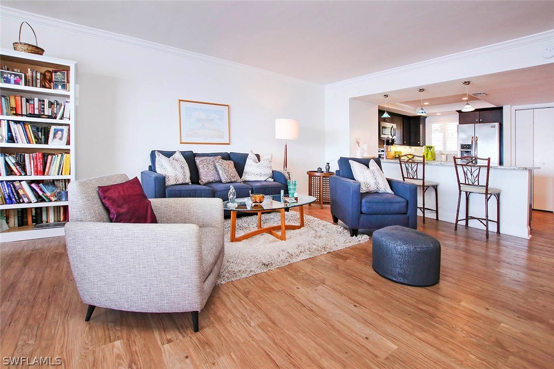 15011 Punta Rassa Road, Unit 204 Fort Myers, FL 33908 - Photo 4 of 23 a living room with furniture and a book shelf