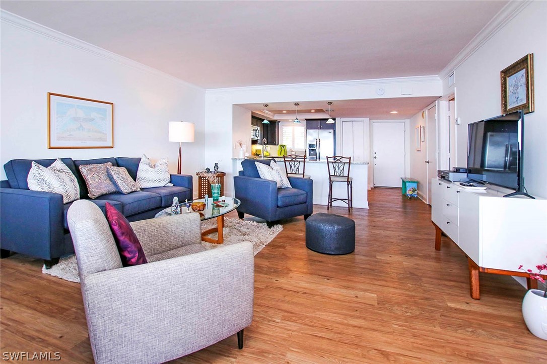 15011 Punta Rassa Road, Unit 204 Fort Myers, FL 33908 - Photo 5 of 23 a living room with furniture and a flat screen tv