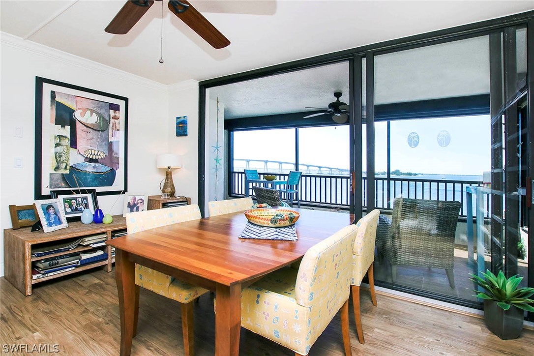 15011 Punta Rassa Road, Unit 204 Fort Myers, FL 33908 - Photo 7 of 23 a dining room with furniture a rug and a large window