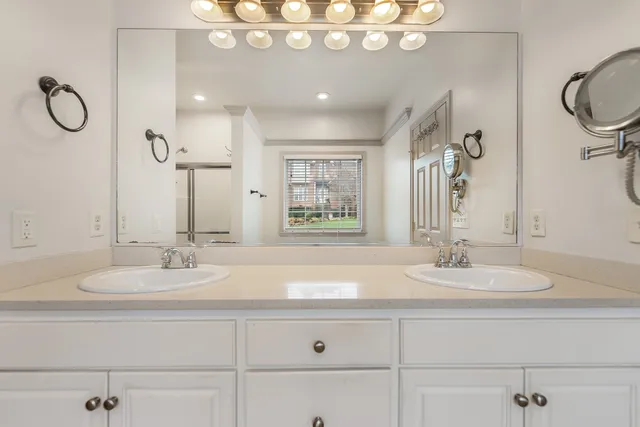 a bathroom with a granite countertop sink mirror and vanity
