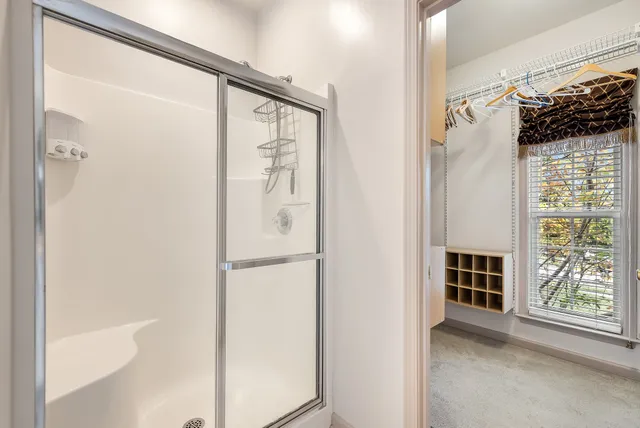 a view of walk in closet with clothes