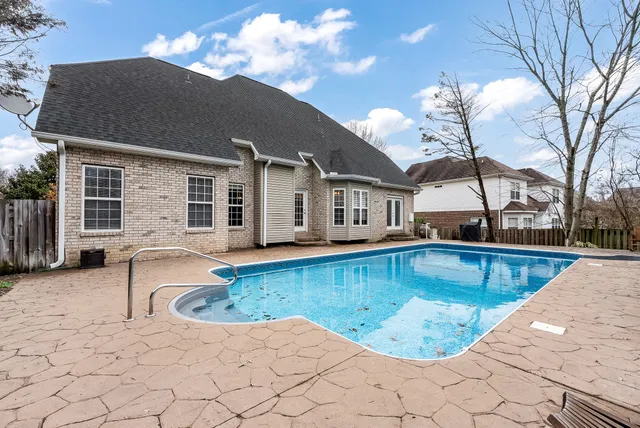 a view of a house with swimming pool in front of it