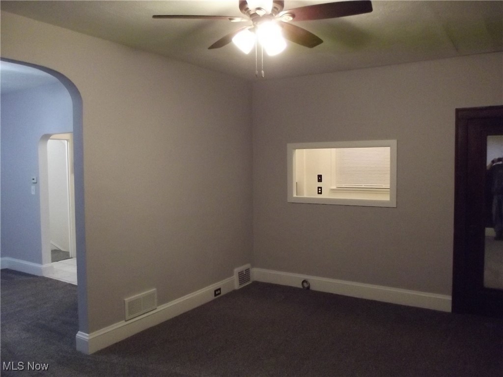 3904 Snow Road Cleveland, OH 44134 - Photo 9 of 50 Unfurnished room featuring ceiling fan and dark carpet