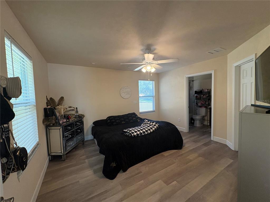 13002 Southwest 174th Street Archer, FL 32618 - Photo 4 of 10 a bedroom with a bed and wooden floor