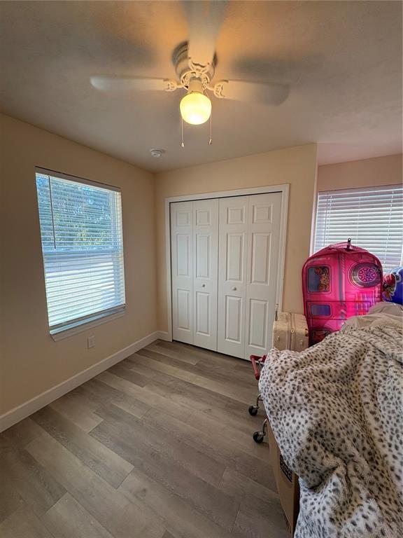 13002 Southwest 174th Street Archer, FL 32618 - Photo 5 of 10 a view of a bedroom with natural light and wooden floor