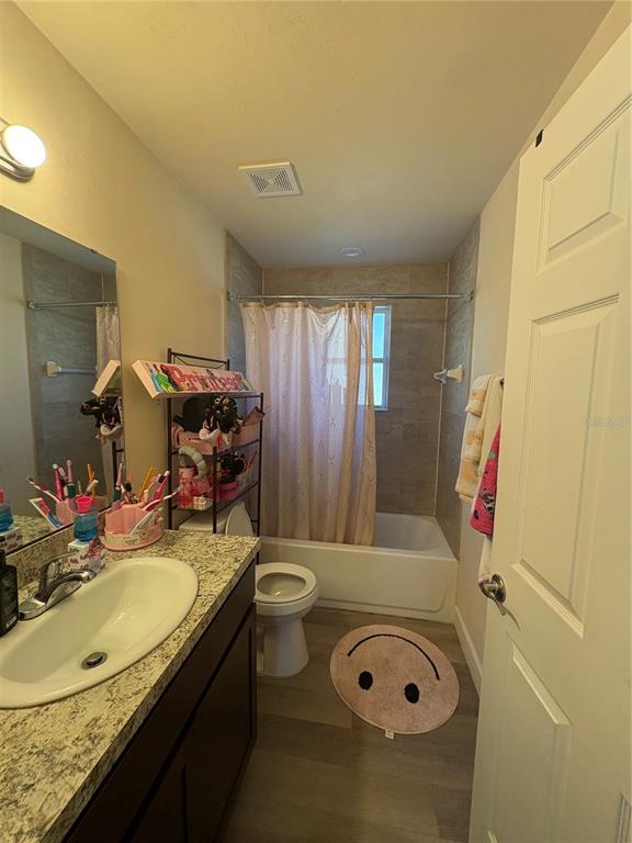 13002 Southwest 174th Street Archer, FL 32618 - Photo 8 of 10 a bathroom with a granite countertop sink a mirror and a bathtub