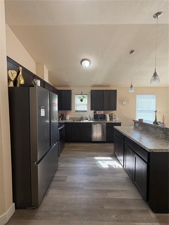 13002 Southwest 174th Street Archer, FL 32618 - Photo 9 of 10 a large kitchen with stainless steel appliances a refrigerator and a sink
