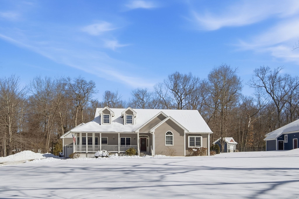 56 Old Lyman Road South Hadley, MA 01075 - Photo 1 of 40 a view of a white house with a big yard and large trees