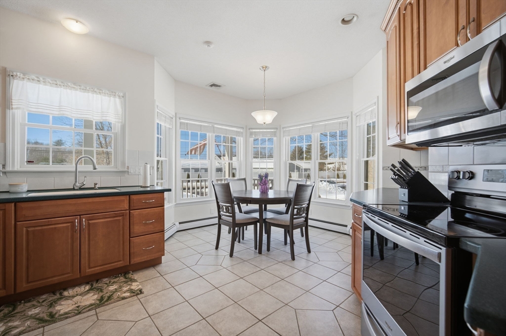 56 Old Lyman Road South Hadley, MA 01075 - Photo 13 of 40 a kitchen with granite countertop a sink cabinets and stainless steel appliances
