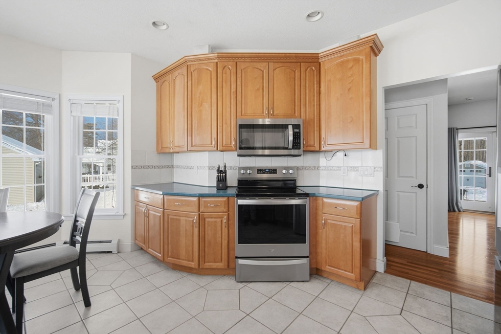 56 Old Lyman Road South Hadley, MA 01075 - Photo 15 of 40 a kitchen with stainless steel appliances granite countertop a stove a sink and a refrigerator