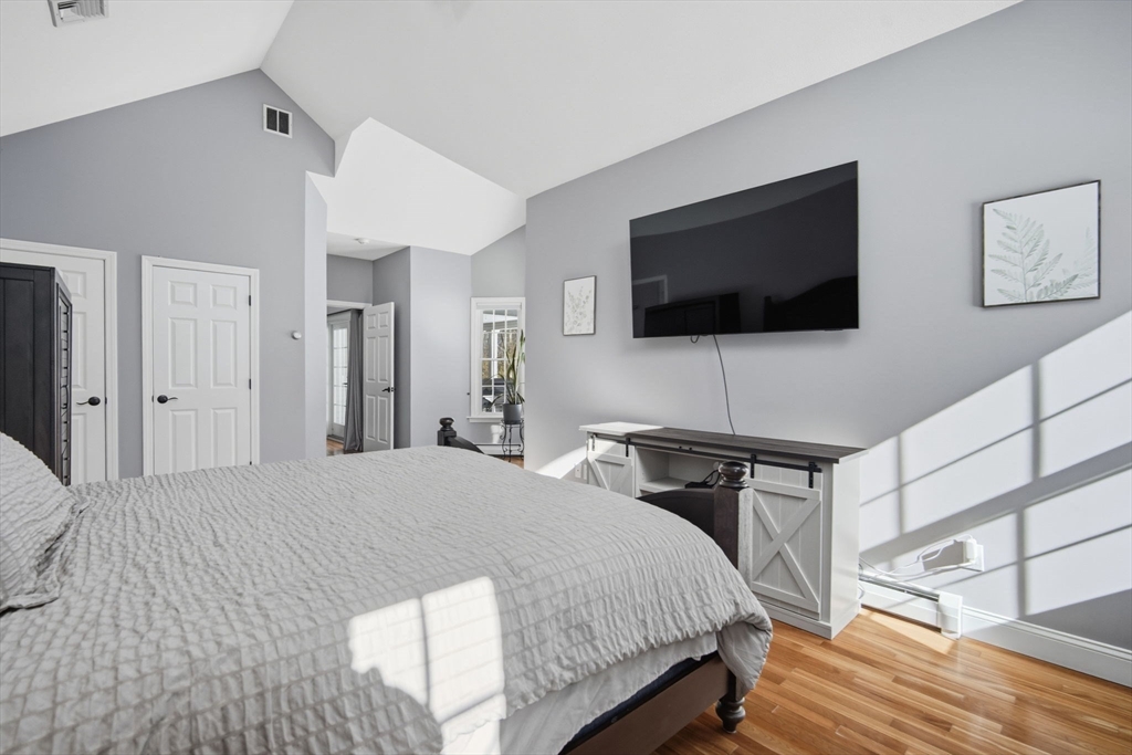56 Old Lyman Road South Hadley, MA 01075 - Photo 20 of 40 a bedroom with a bed and a flat screen tv