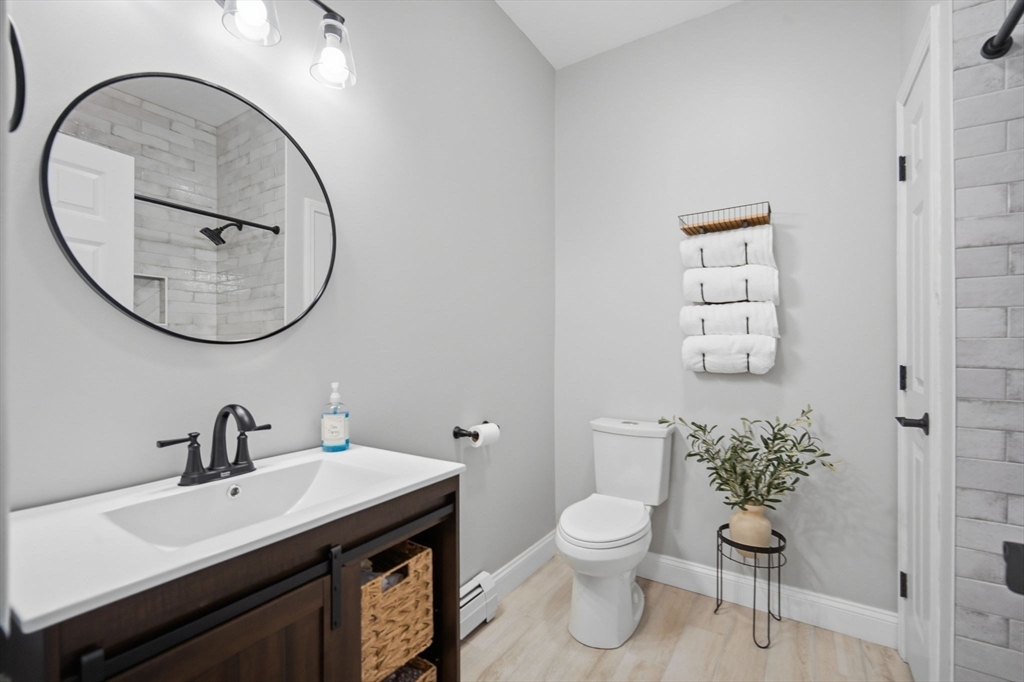 56 Old Lyman Road South Hadley, MA 01075 - Photo 28 of 40 a bathroom with a toilet a sink and mirror