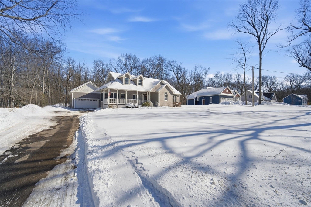56 Old Lyman Road South Hadley, MA 01075 - Photo 3 of 40 a view of a white house with a snow on the yard