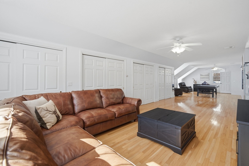 56 Old Lyman Road South Hadley, MA 01075 - Photo 34 of 40 a living room with furniture and a chandelier
