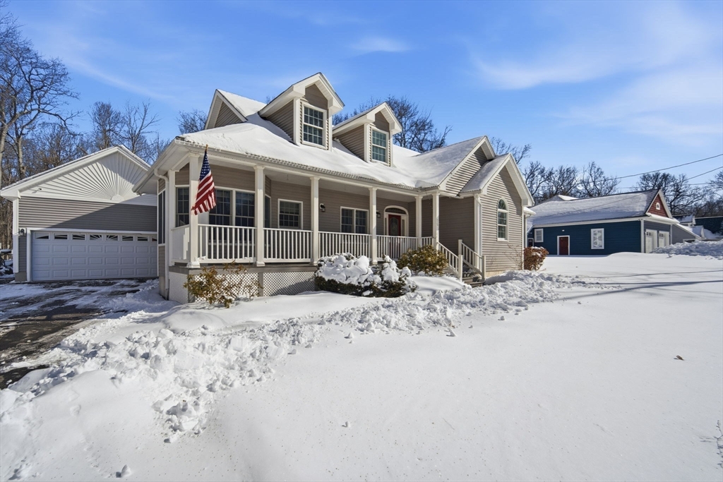 56 Old Lyman Road South Hadley, MA 01075 - Photo 4 of 40 a front view of a house with a yard covered with snow