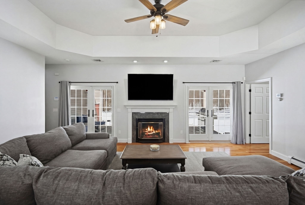 56 Old Lyman Road South Hadley, MA 01075 - Photo 8 of 40 a living room with furniture a flat screen tv and a fireplace